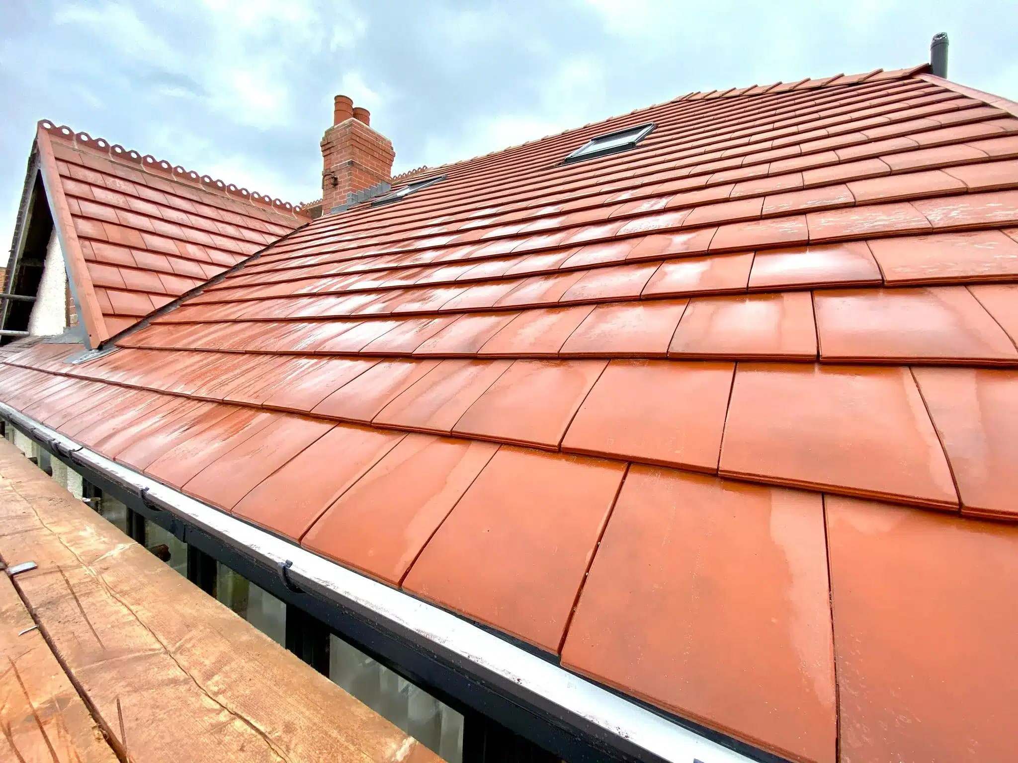 Roofer replacing tiles during a roof repair