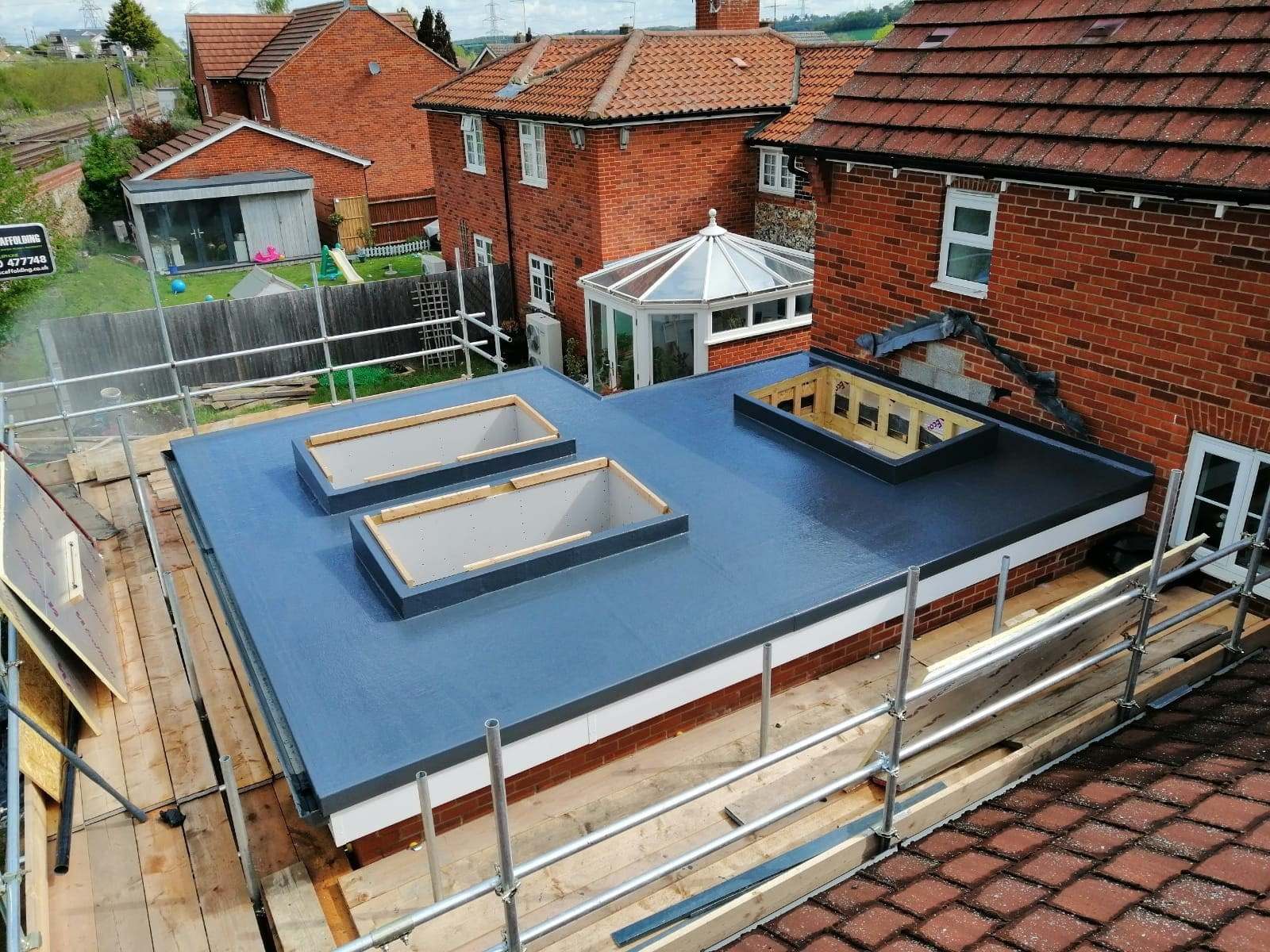 Flat roof covering laid over new decking on a house extension